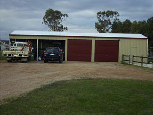 farm sheds with car and truck parked